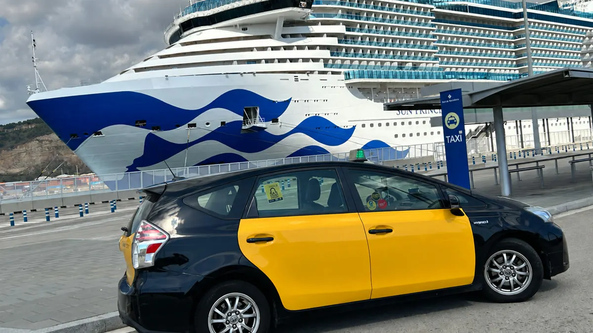 Our Toyota Prius+ taxi beside a cruise ship at Barcelona cruise port